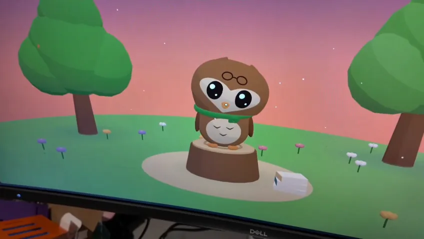 Hoot's animated owl wearing glasses and a scarf, standing on a tree stump in a colorful woodland scene.